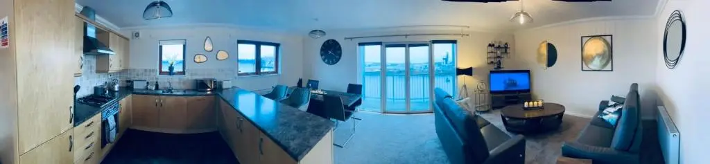 a large kitchen with blue counter tops in a room at Central Cosy Riverview Apartment 2 bed, 2 bath, Free Parking / WiFi in Inverness