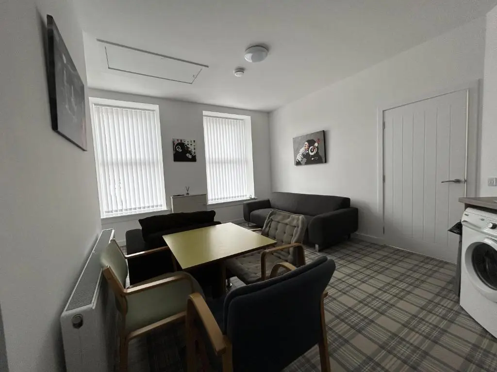 a living room with a table and a couch at Buckie Haven 3 Bed Contractors Business Travellers in Buckie