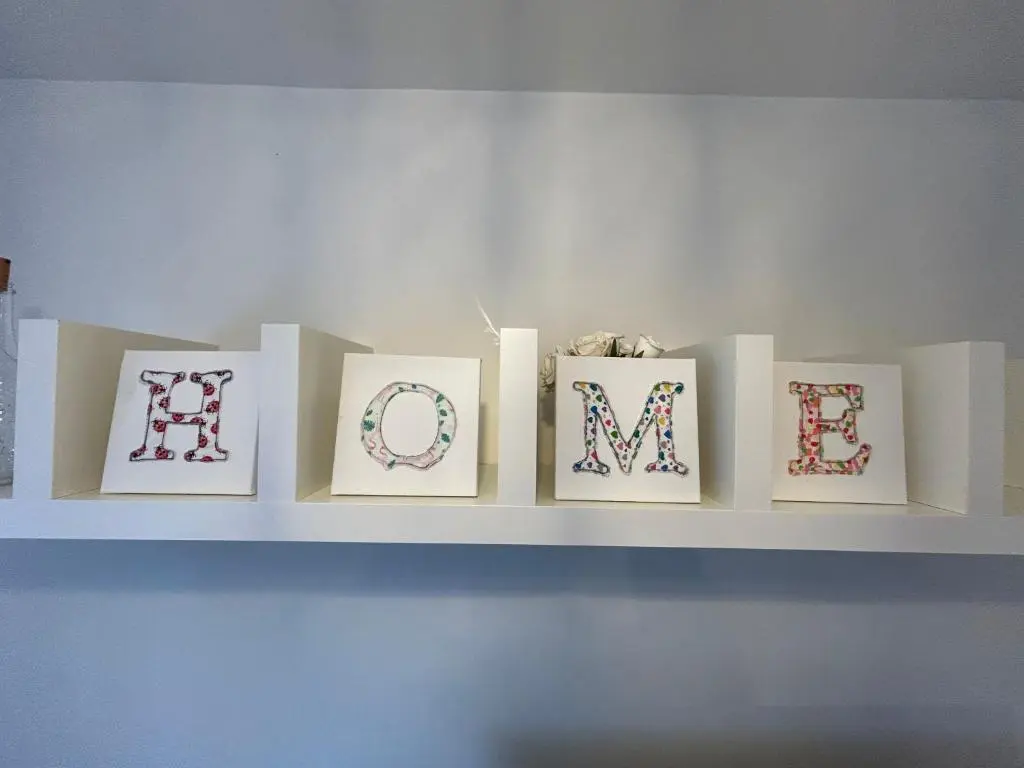 a shelf with four framed art on it at Buckie Haven 3 Bed Contractors Business Travellers in Buckie