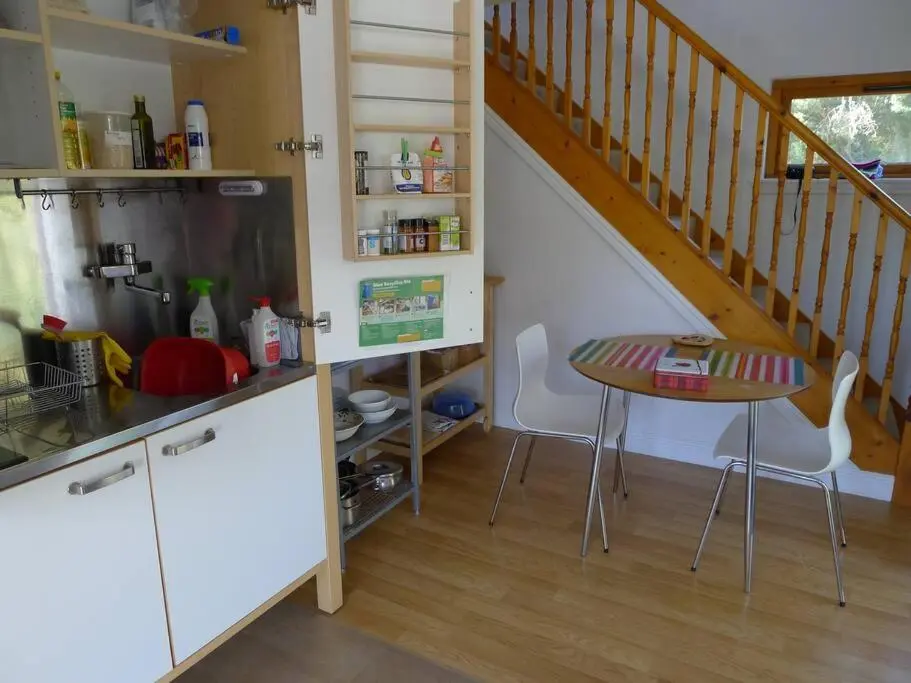 a small kitchen with a table and a staircase at The Bothy, Nethy Bridge in Nethy Bridge