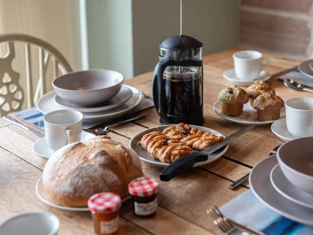 a table with bread and pastries on it at 2 Bed in South Kessock CA324 in Inverness