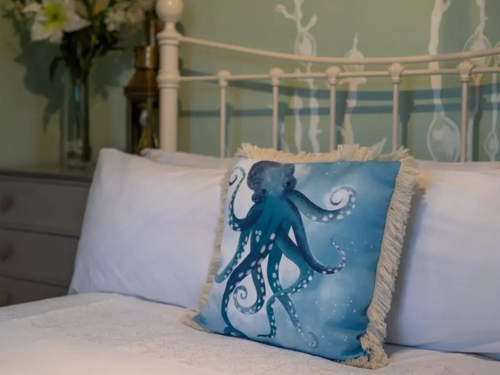 an octopus pillow sitting on top of a bed at 2 Bed in South Kessock CA324 in Inverness