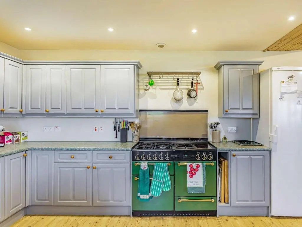 a kitchen with white cabinets and a stove top oven at 4 Bed in Grantown-on-Spey CA383 in Aitnoch