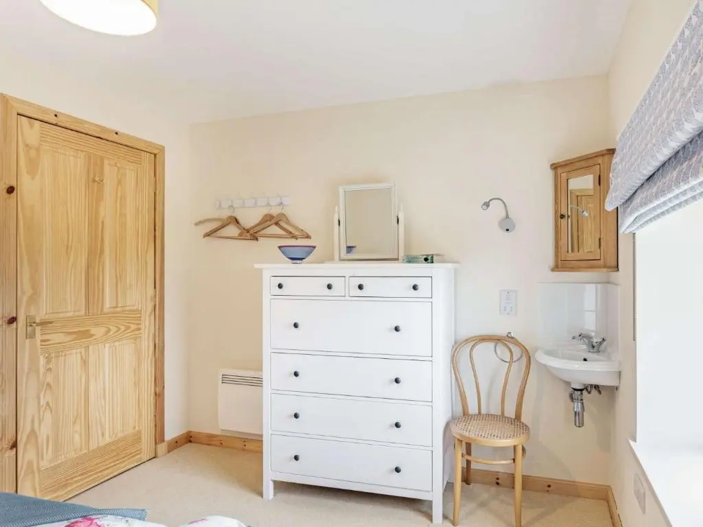 a bedroom with a white dresser and a sink at 4 Bed in Grantown-on-Spey CA383 in Aitnoch