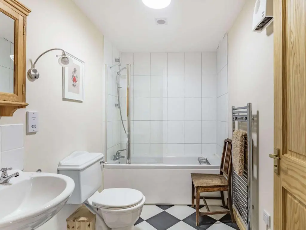 a bathroom with a tub and a toilet and a sink at 4 Bed in Grantown-on-Spey CA383 in Aitnoch