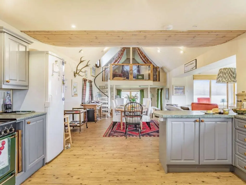 a kitchen with white cabinets and a dining room at 4 Bed in Grantown-on-Spey CA383 in Aitnoch