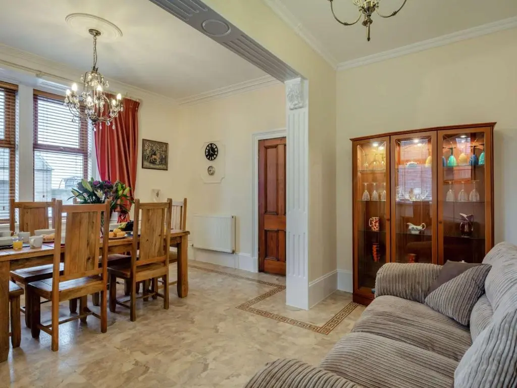 a living room with a couch and a dining room at 3 Bed in Buckie 89824 in Buckie