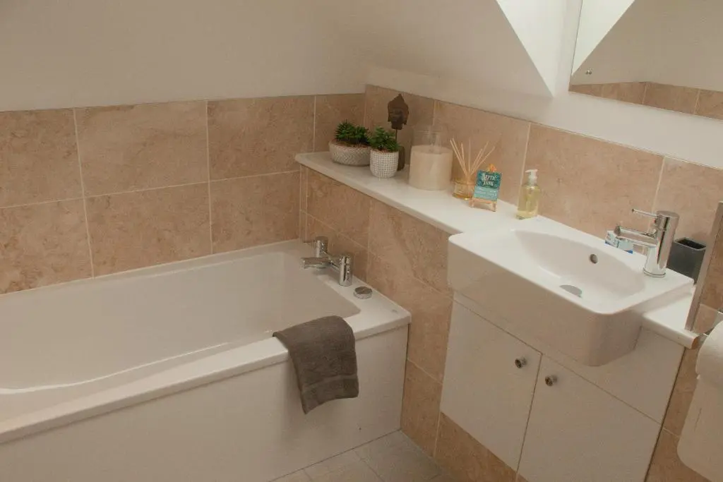 a bathroom with a sink and a bath tub and a sink at Woodhaus Aviemore Lodge in Aviemore