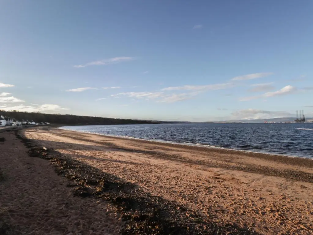 a sandy beach with the ocean in the background at Flat 4, The Byre in Cromarty