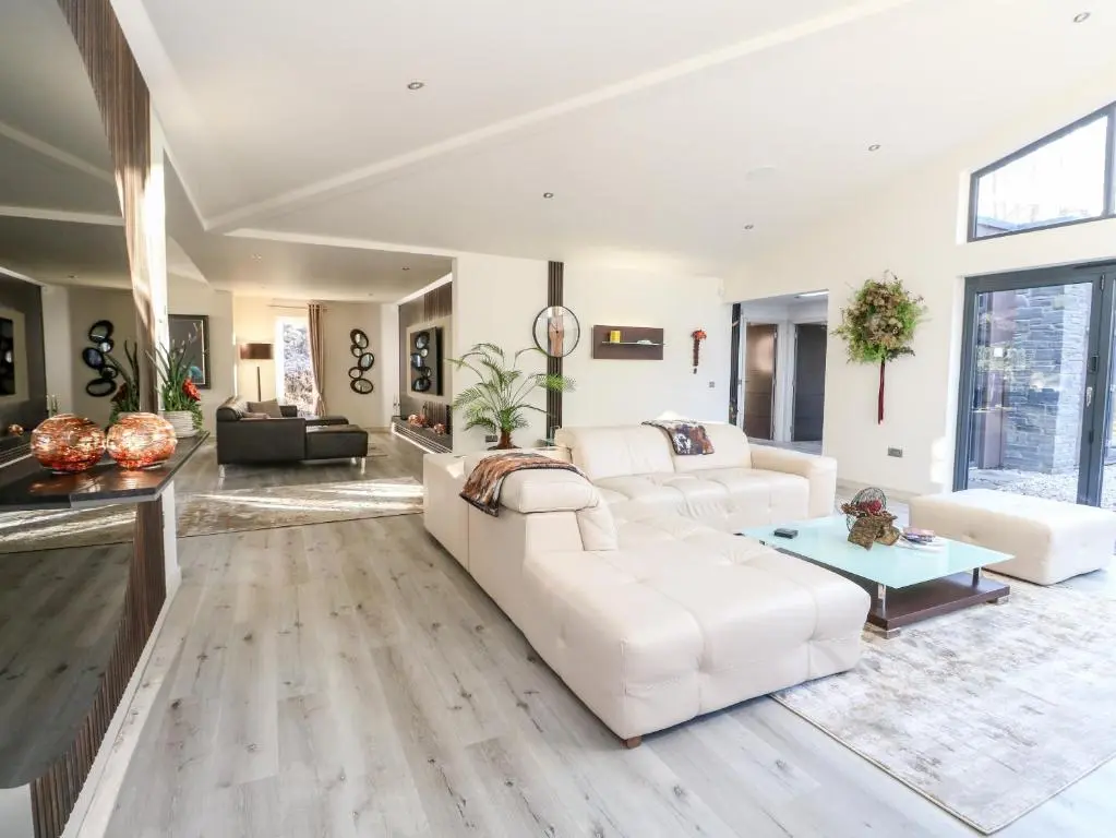 a living room with a white couch and a table at Heilan Roo in Pitlochry
