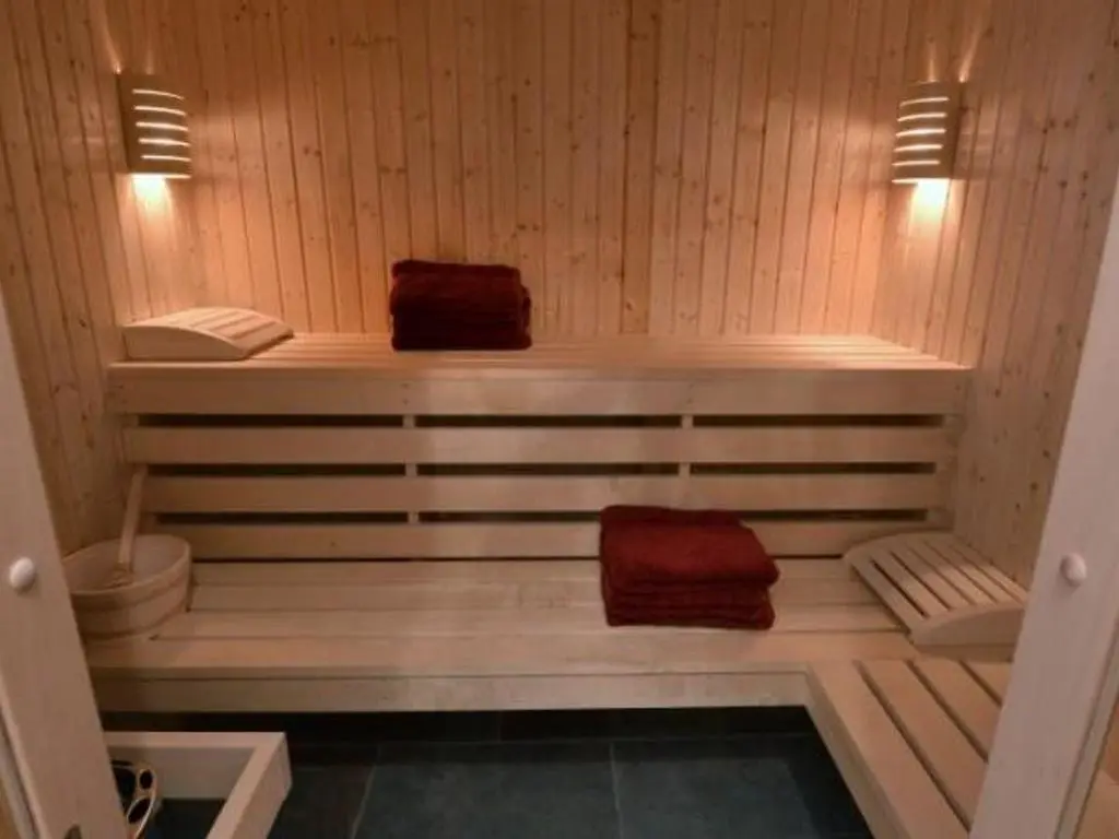a sauna with two towels sitting on a wooden bench at Glen View Lodge in Inverness
