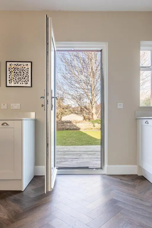 an open door with a view of a yard at Ness at the Park in Inverness