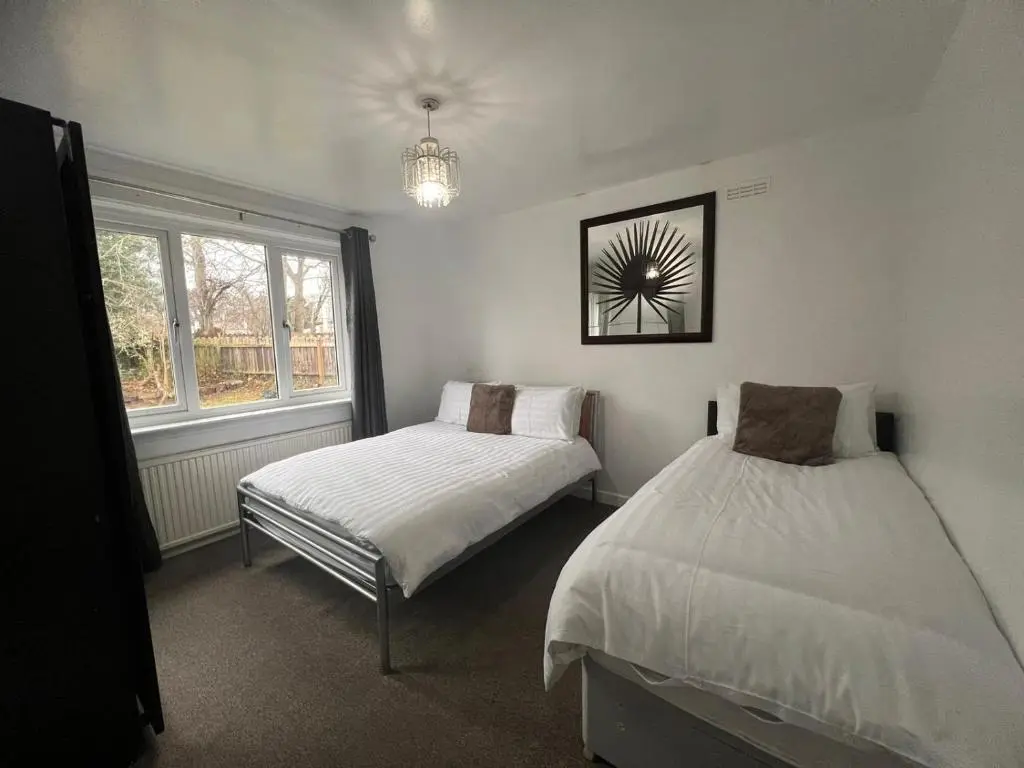 a bedroom with two beds and a window at Shared House in Inverness in Inverness