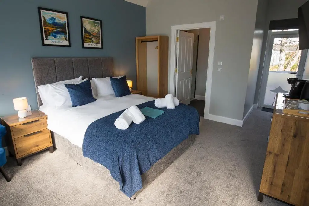 a bedroom with a bed with towels on it at The Crossing in Kingussie