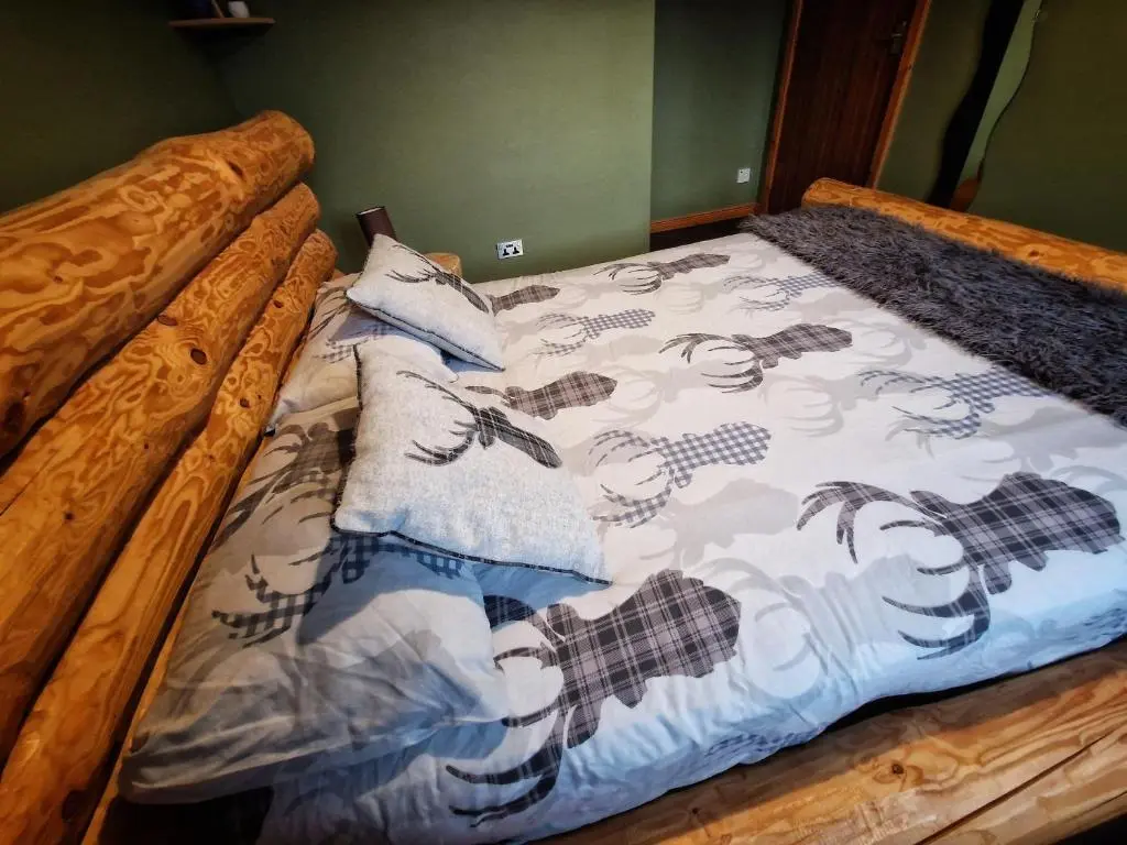 a bed with a blanket on top of it at Mountain View No12 in Aviemore
