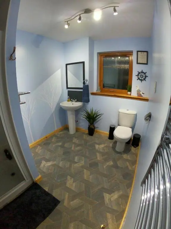 a bathroom with a toilet and a sink at Mountain View No12 in Aviemore