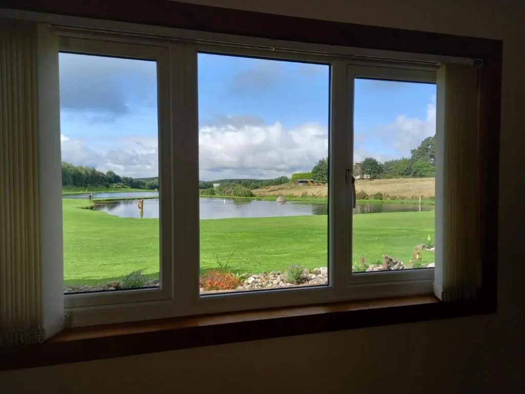 a window with a view of a body of water at The Boathouse in Longmorn