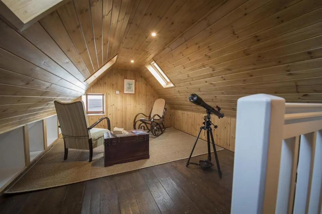 a room with a camera and a chair in a room at The Wee House in Pennan