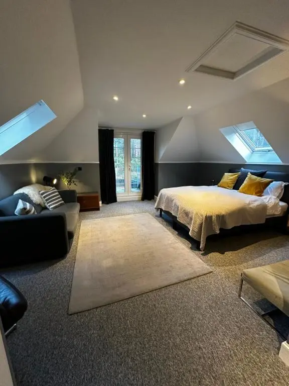 a large bedroom with a bed and a couch at Findhorn Lodge in Findhorn
