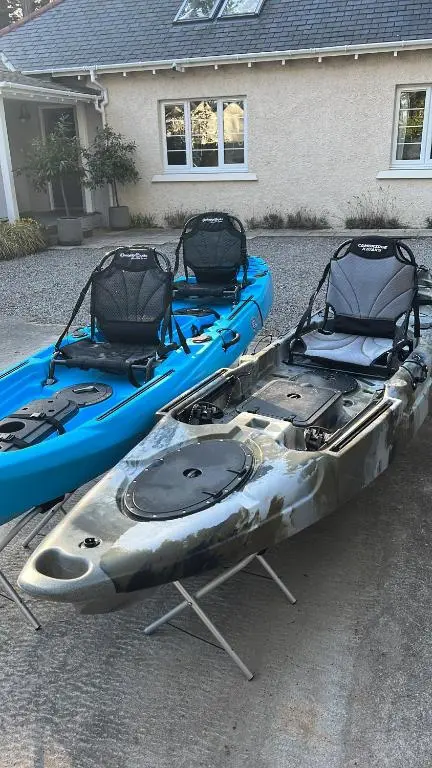 two kayaks are parked in a parking lot at Findhorn Lodge in Findhorn