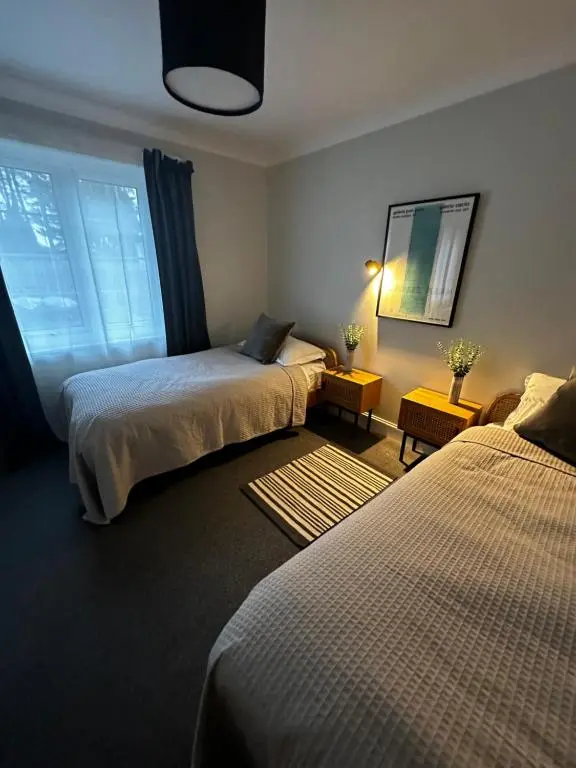 a hotel room with two beds and a window at Findhorn Lodge in Findhorn