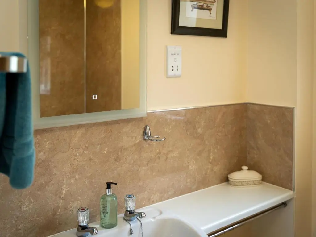 a bathroom with a sink and a mirror at Holiday Home Falcon Lodge by Interhome in Aviemore