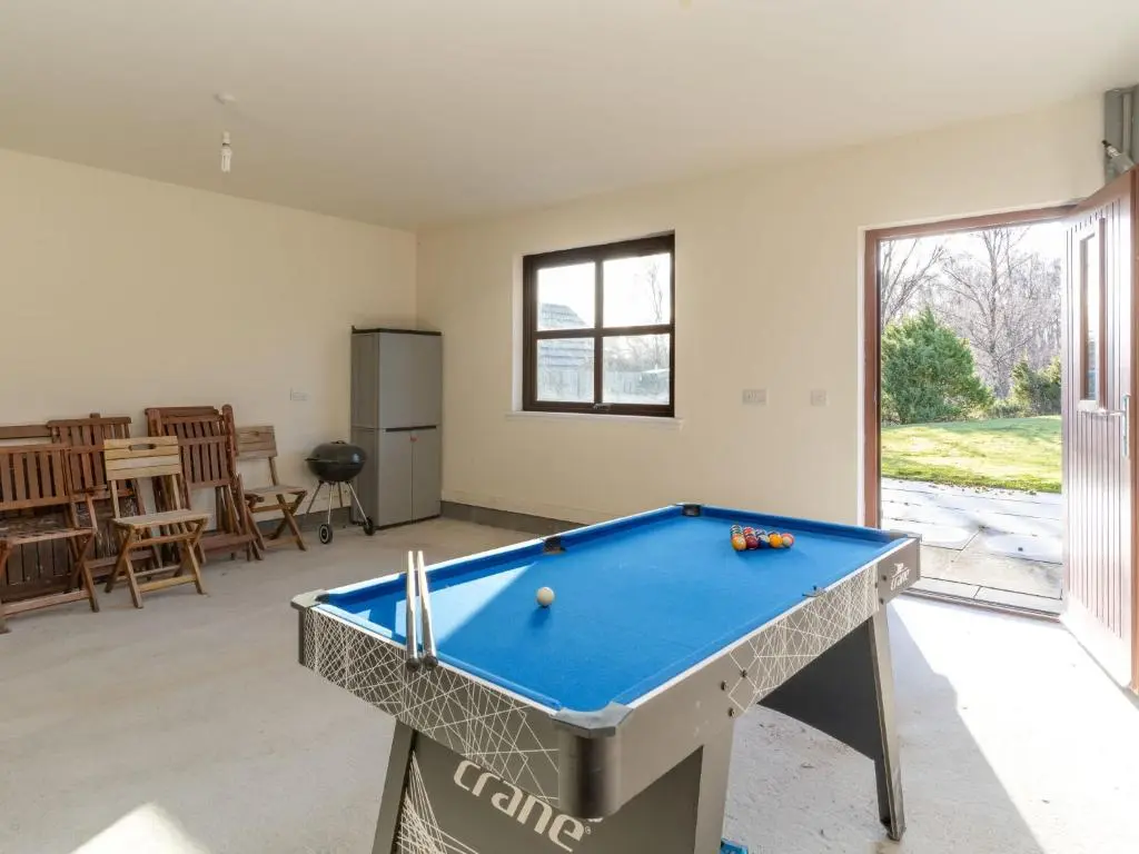 a living room with a pool table in it at Villa Pineways by Interhome in Aviemore