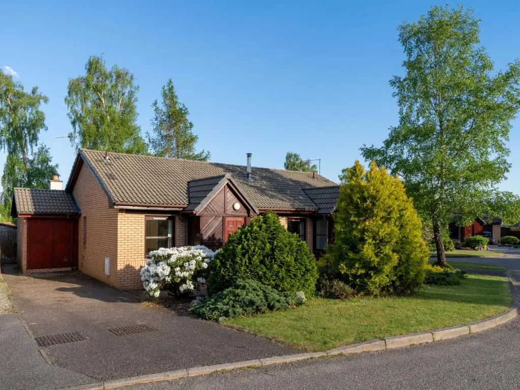 a house on the side of a street at Holiday Home Skye Premier by Interhome in Aviemore