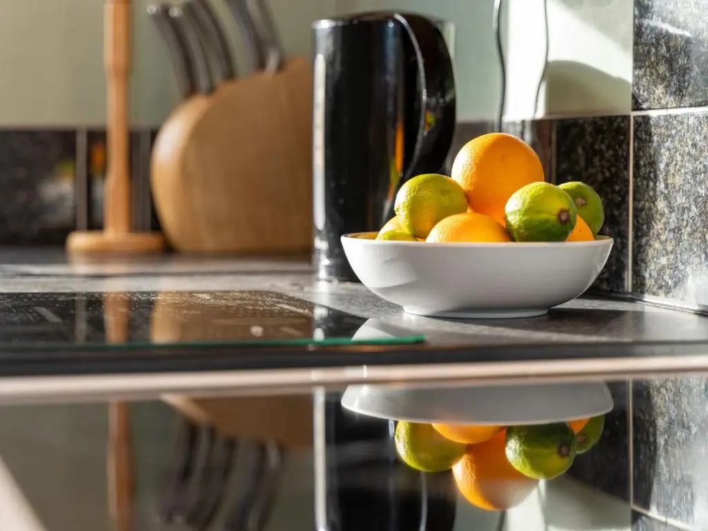 a bowl of fruit on a glass table at Holiday Home Glenfiddich by Interhome in Aviemore