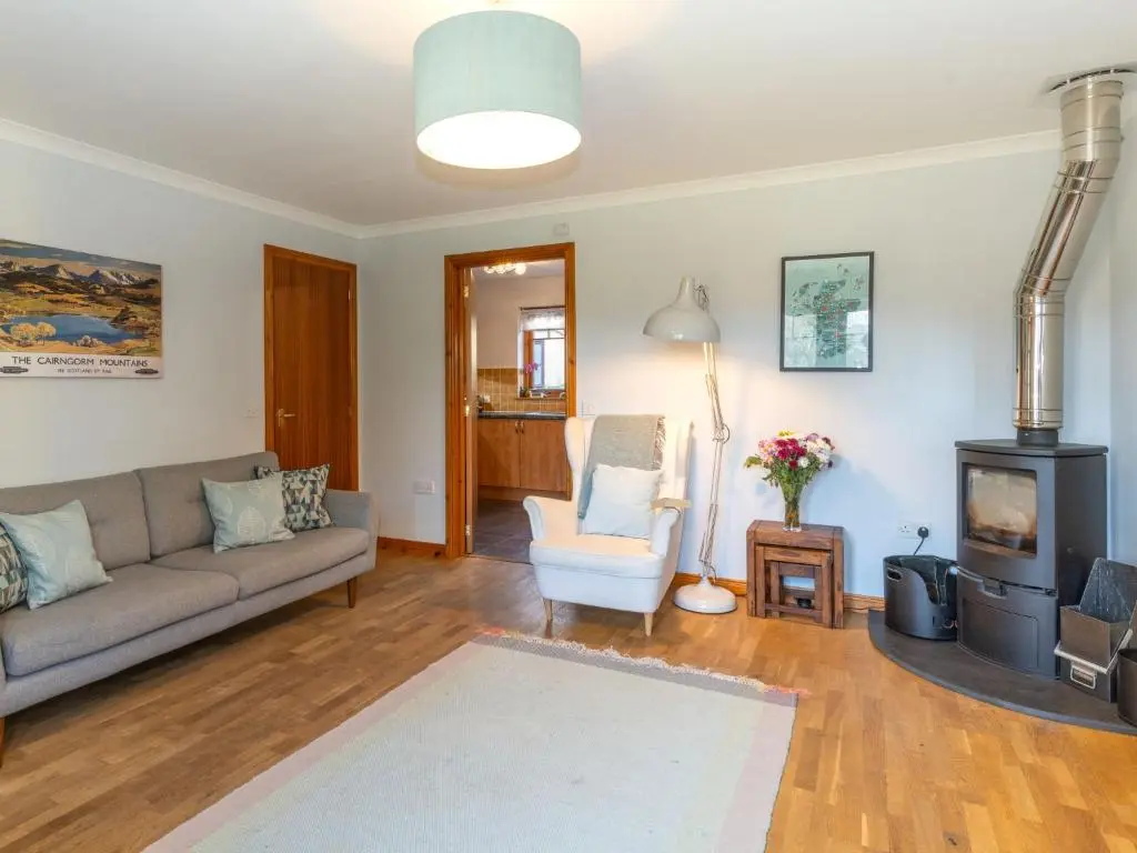 a living room with a couch and a fireplace at Holiday Home Cosagach Cottage by Interhome in Aviemore