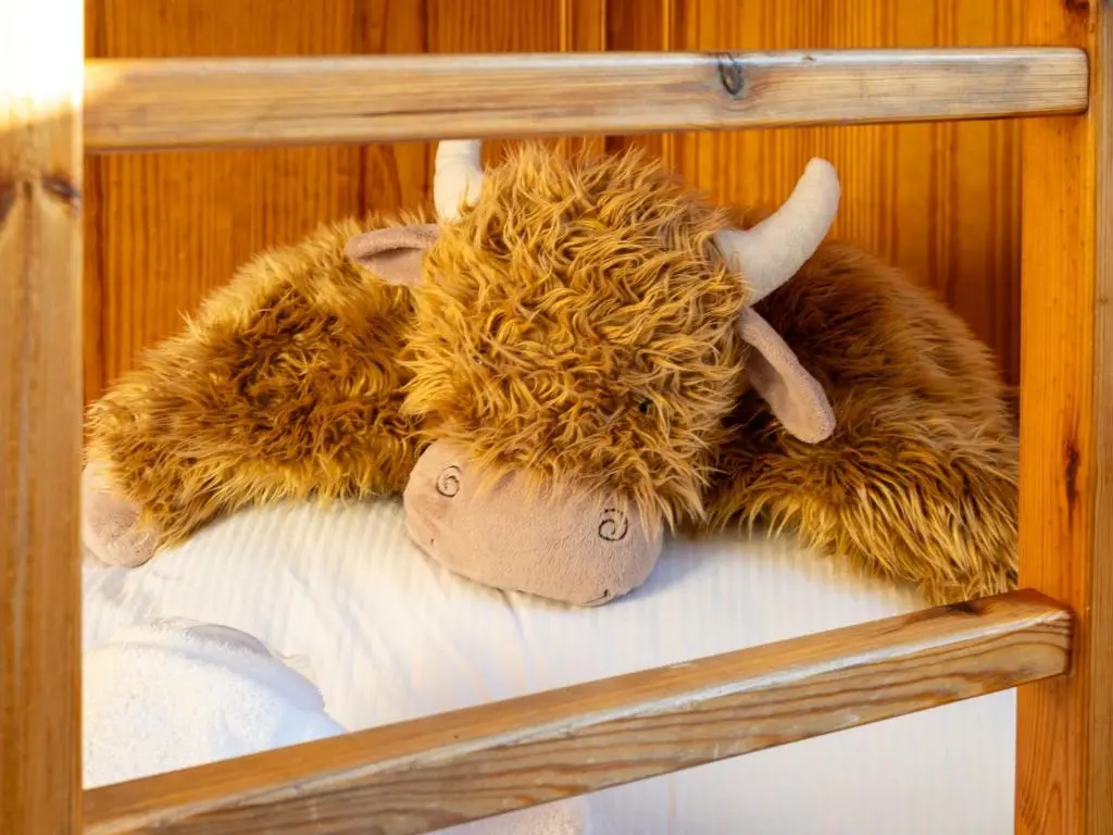 a group of stuffed animals laying on a bed at Villa Craigmore Lodge by Interhome in Aviemore