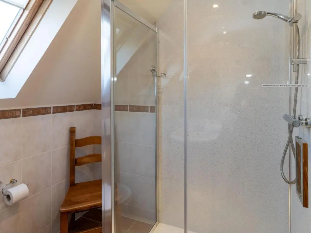 a shower with a glass door in a bathroom at Villa Craigmore Lodge by Interhome in Aviemore