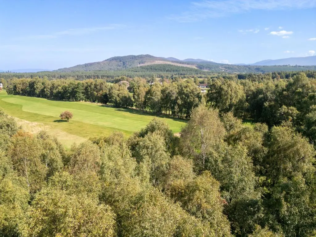 an aerial view of a golf course with trees at Holiday Home Glenpark by Interhome in Aviemore