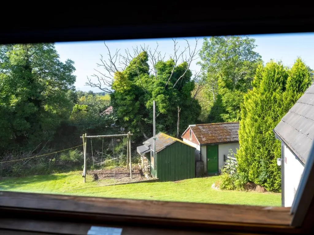 a view from a window of a house with a field at Holiday Home Lower Curr by Interhome in Skye of Curr