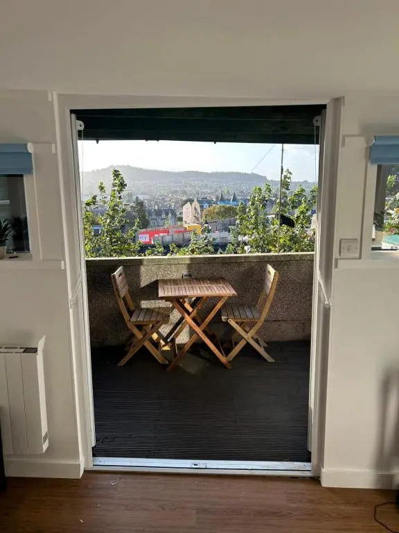 a balcony with a table and chairs and a view at Floras View in Inverness