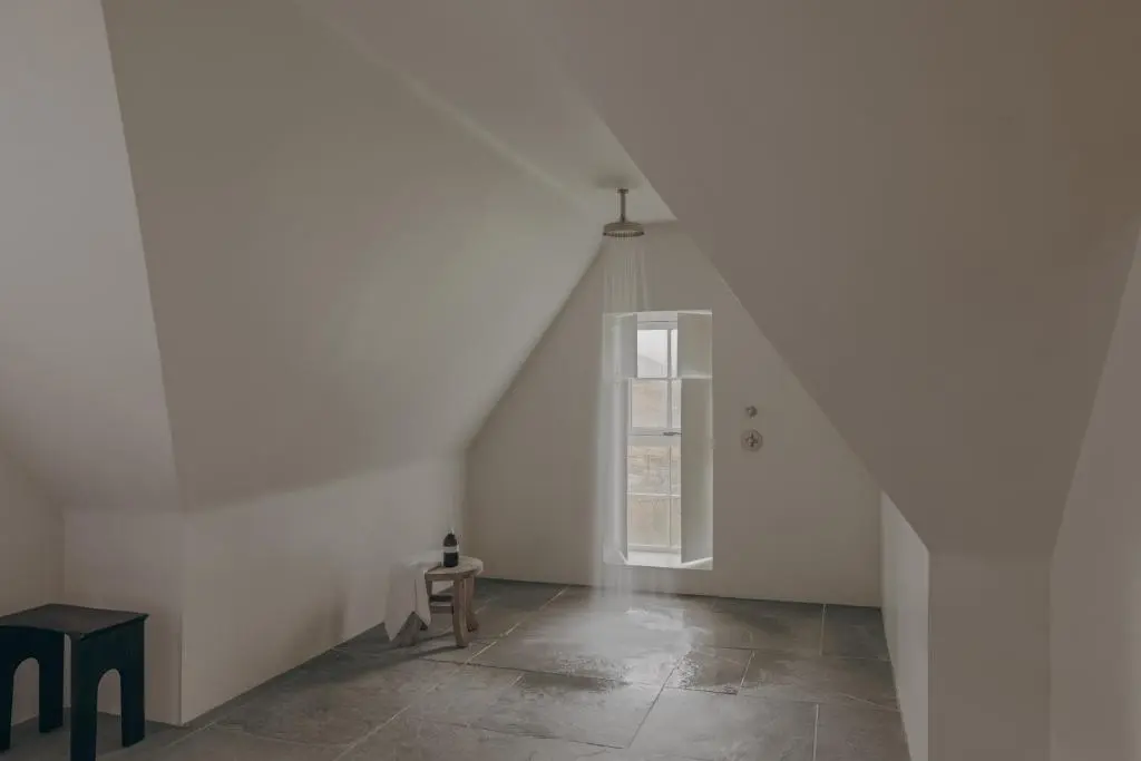 an empty white room with a table and a window at Laggan Cottage - Charming home along River Gairn with unique panoramic room in Ballater