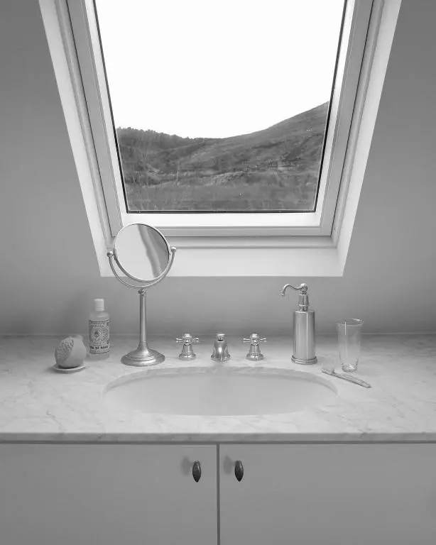a bathroom sink with a mirror under a window at Laggan Cottage - Charming home along River Gairn with unique panoramic room in Ballater
