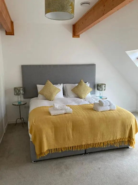 a bedroom with a large bed with towels on it at Highland Holiday Home in Contin