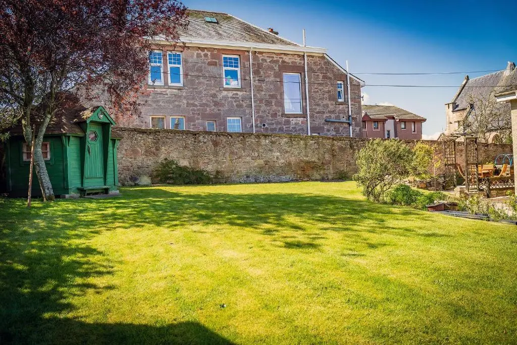 a large brick house with a grass yard at Fonthill Bed and Breakfast Nairn in Nairn