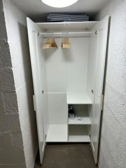 a white cabinet in a room with a wall at Riverview Apartment, Inverness in Inverness