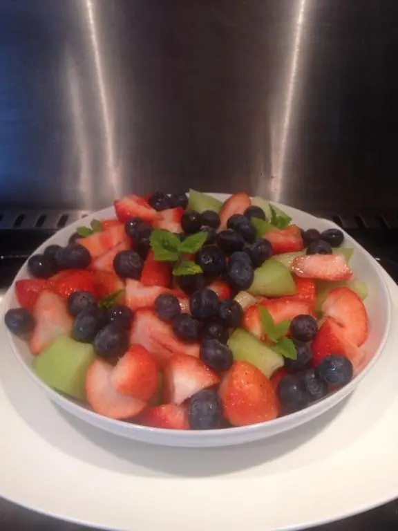 a bowl of fruit on a plate on a stove at Ardlogie Guest House in Aviemore