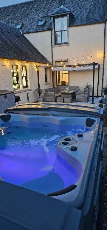 a large swimming pool in front of a house at Antfield House in Inverness