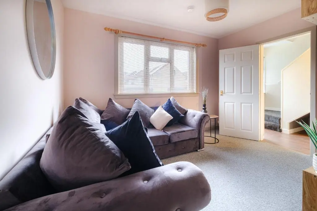 a living room with a leather couch and a window at Banchory House - SJA Stays - 2 Bed House in Banchory