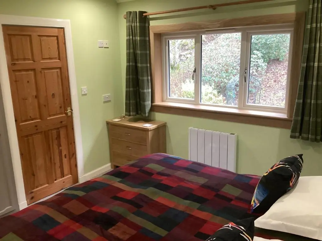 a bedroom with a bed and a window at Taigh Sealladh F\u00e8idh B&B in Fort Augustus
