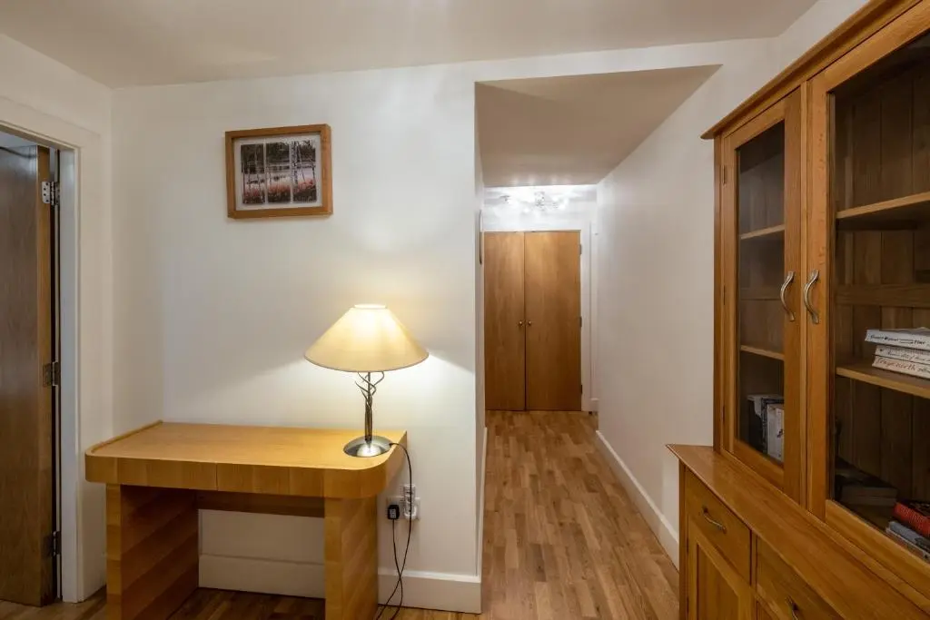 a room with a desk with a lamp on it at Noble Apartment - Highland Club in Fort Augustus