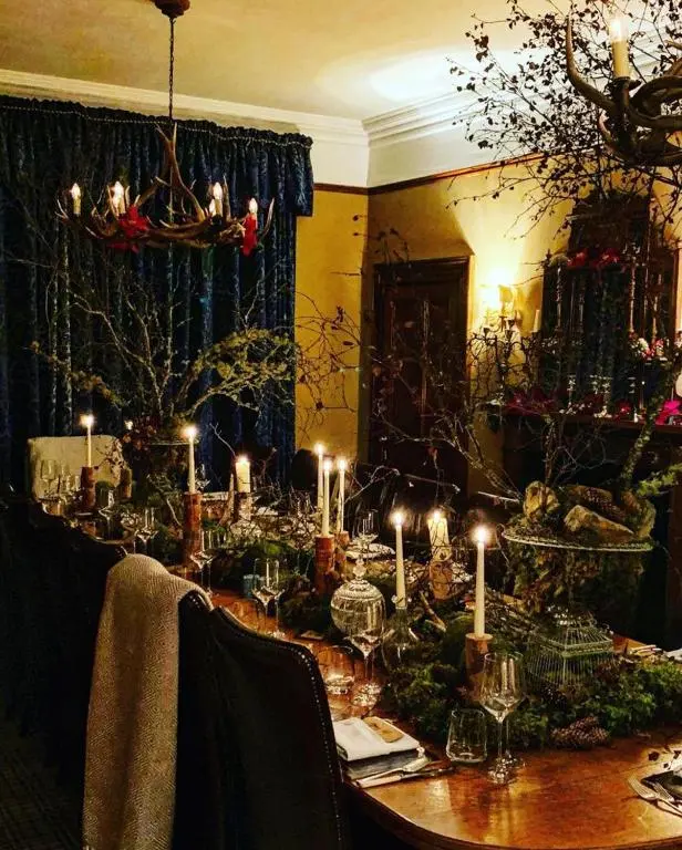 a dining room table with candles on top of it at Caledonian Lodge in Croick