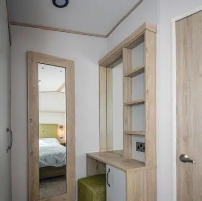 a room with a mirror and a bedroom with a bed at Robyn\u2019s Nest in Lybster