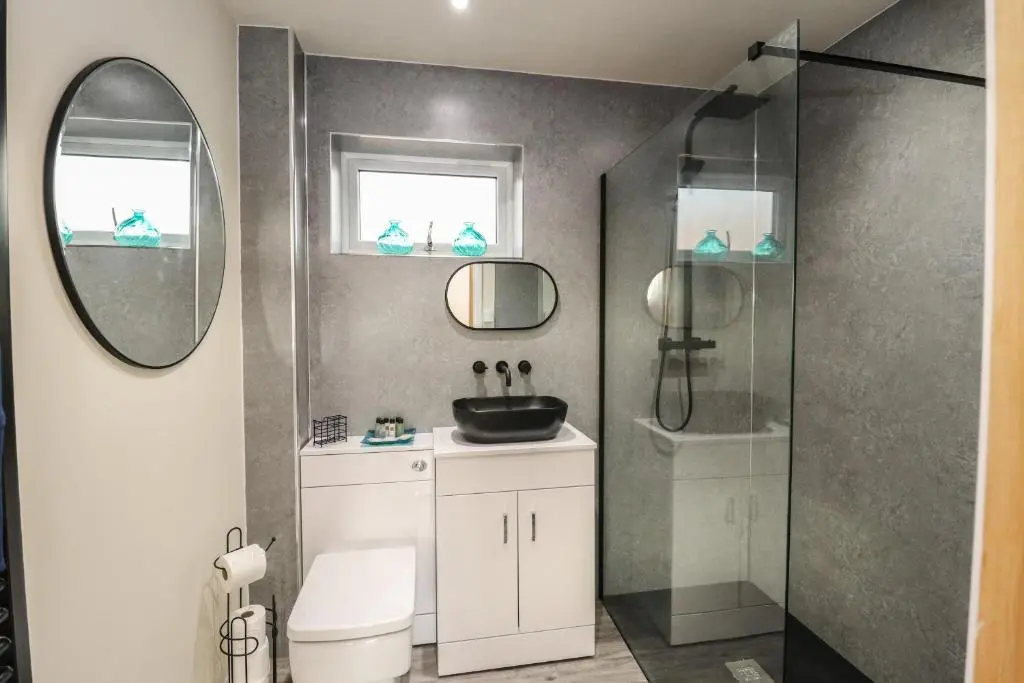 a bathroom with a sink and a shower at Red Squirrel in Dornoch