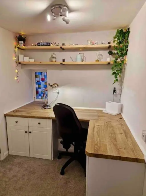 an office with a desk and a chair in a room at Cullen Seaside Cottage in Cullen