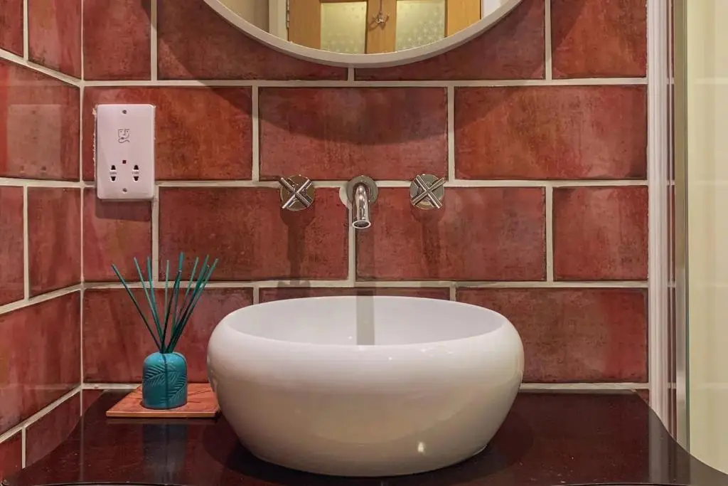 a bathroom with a white sink and a mirror at Unique Highland in Inverness